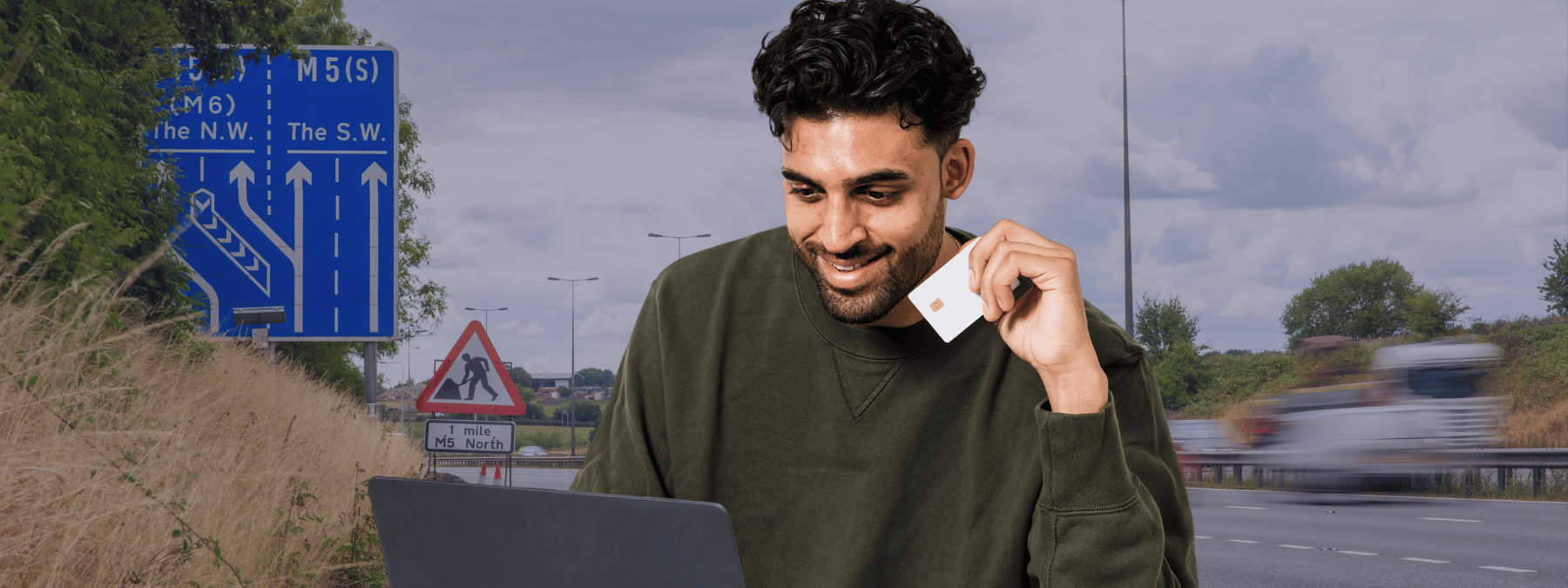 Man on laptop holding a credit card