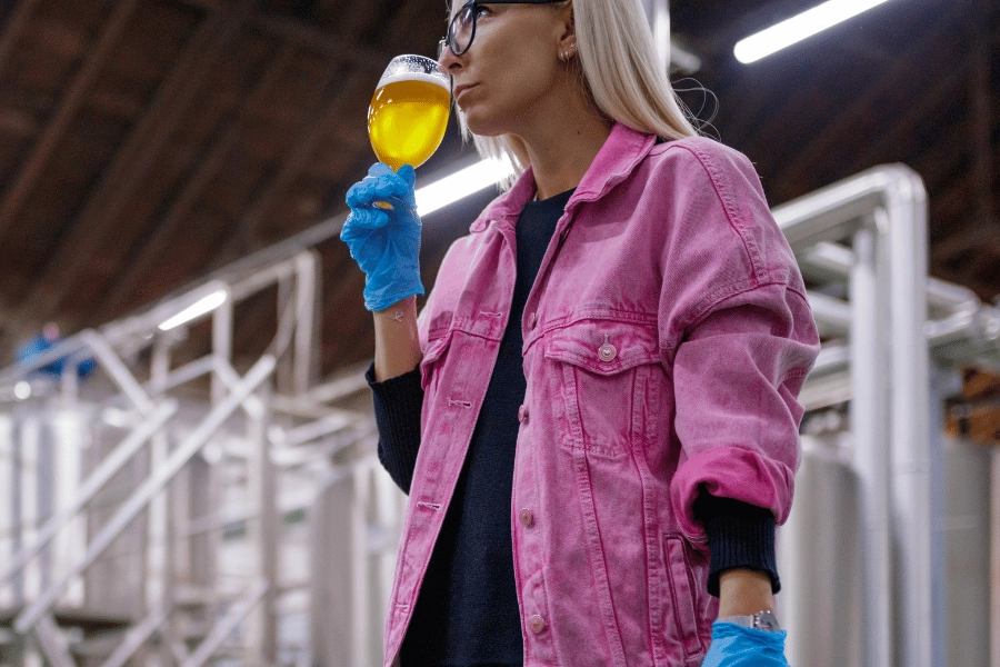 Woman smelling glass of beer