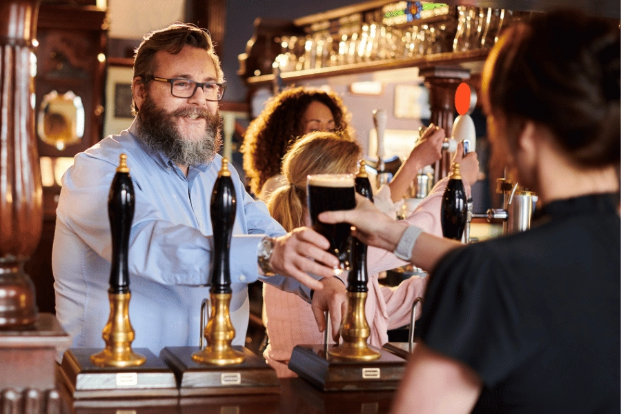 Man serving customer in pub