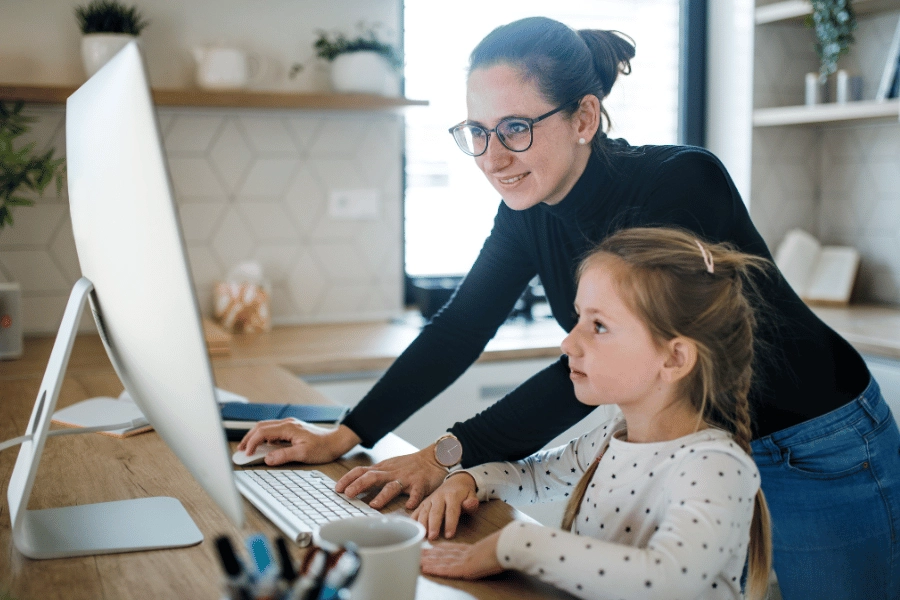 Woman working from home with her daughter