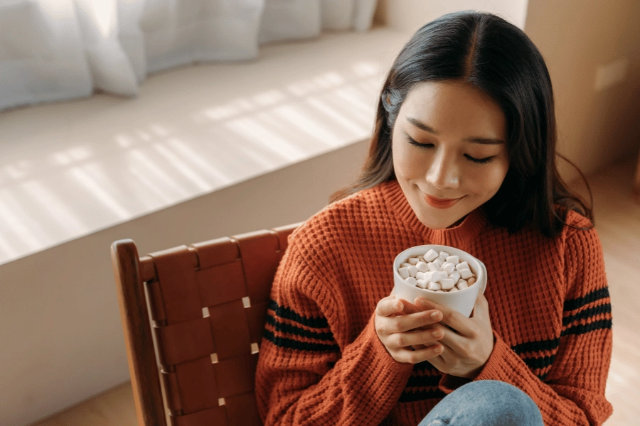 Woman sipping a cup of hot chocolate